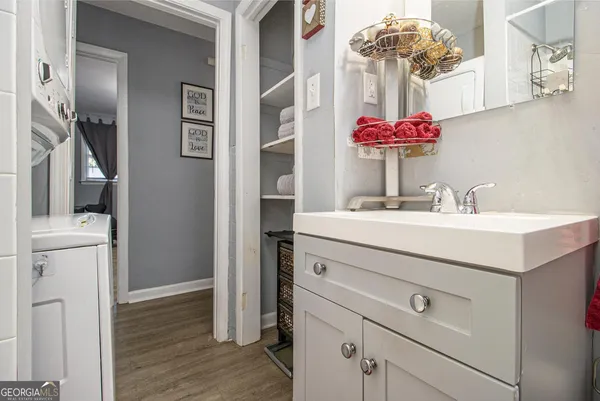 a bathroom with a sink vanity and a mirror