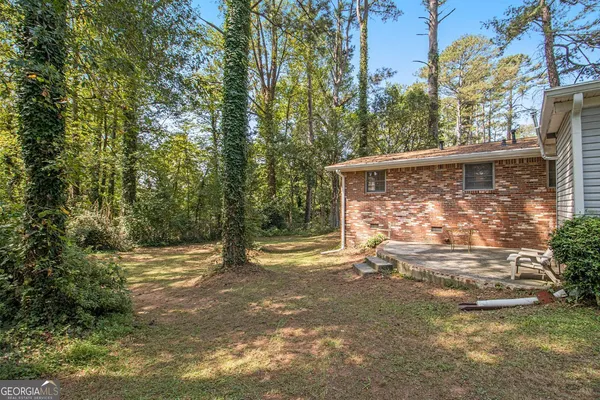 a backyard of a house with table and chairs