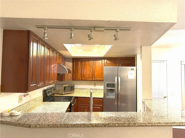 a kitchen with a refrigerator and a sink