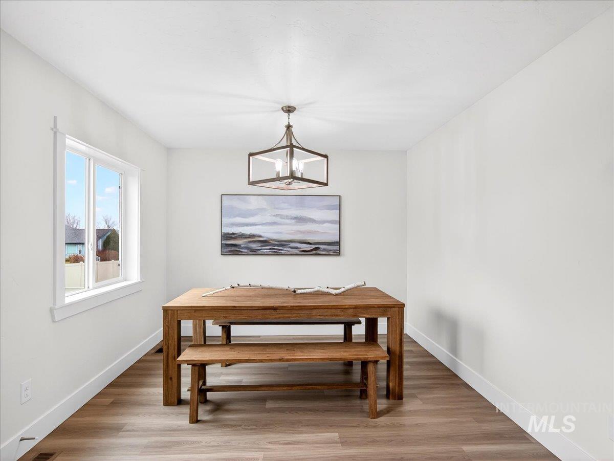 1611 Regency Way Emmett, ID 83617 - Photo 19 of 47 Dining room featuring light wood finished floors and hanging lights