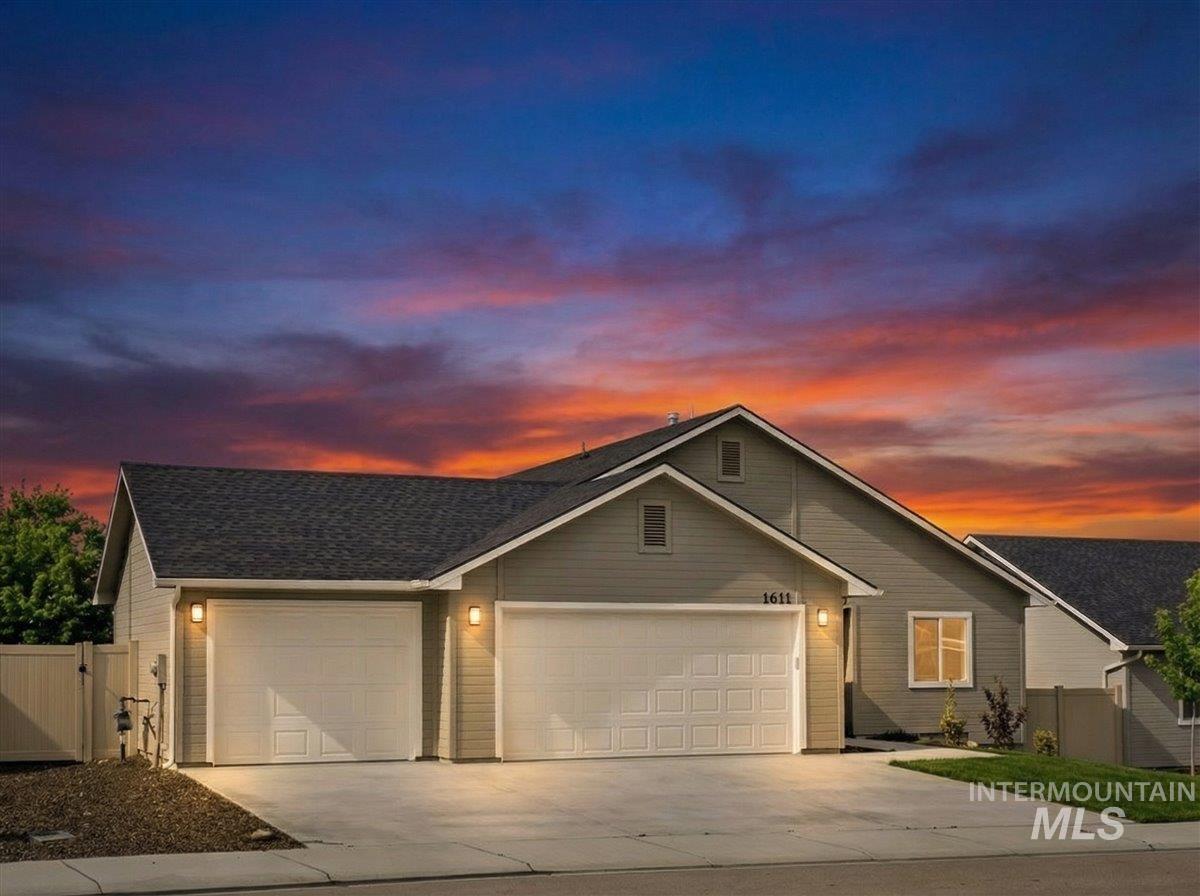 1611 Regency Way Emmett, ID 83617 - Photo 2 of 47 View of front facade featuring a garage, a gate, driveway, and roof with shingles