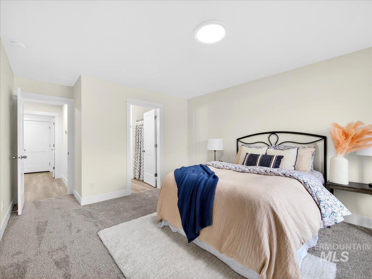 1611 Regency Way Emmett, ID 83617 - Photo 23 of 47 Bedroom with light carpet and connected bathroom