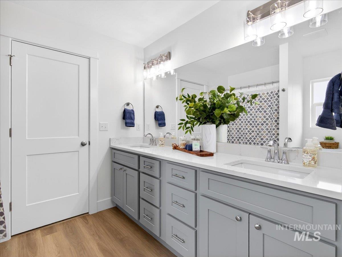 1611 Regency Way Emmett, ID 83617 - Photo 26 of 47 Bathroom featuring double vanity, light wood-style floors, and a shower with curtain