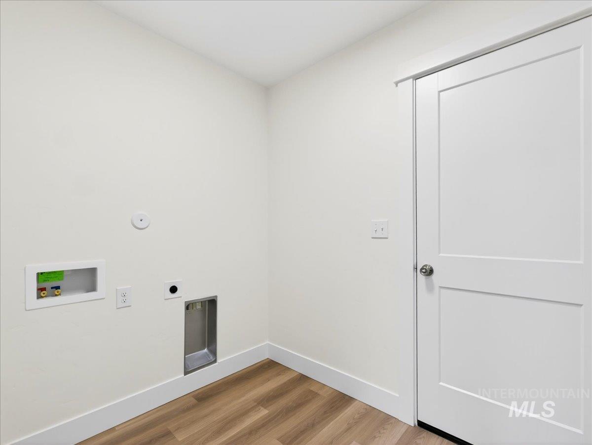 1611 Regency Way Emmett, ID 83617 - Photo 29 of 47 Laundry room with light wood-style flooring, hookup for a washing machine, and electric dryer hookup