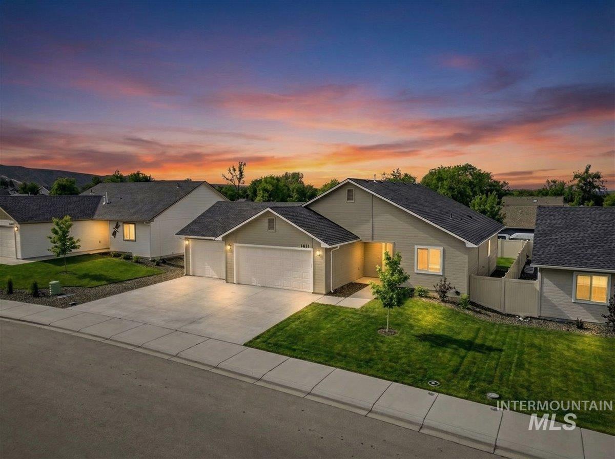 1611 Regency Way Emmett, ID 83617 - Photo 3 of 47 Ranch-style house with an attached garage, concrete driveway, and a shingled roof