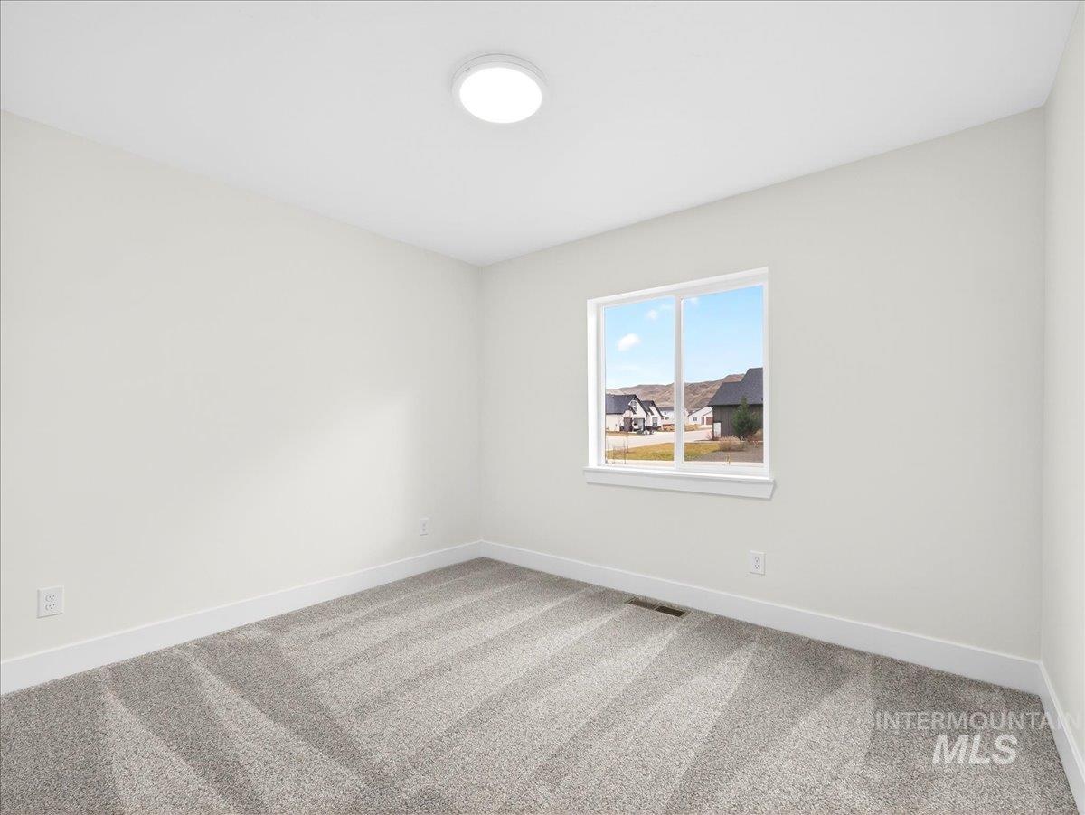 1611 Regency Way Emmett, ID 83617 - Photo 32 of 47 Unfurnished room featuring baseboards and light colored carpet