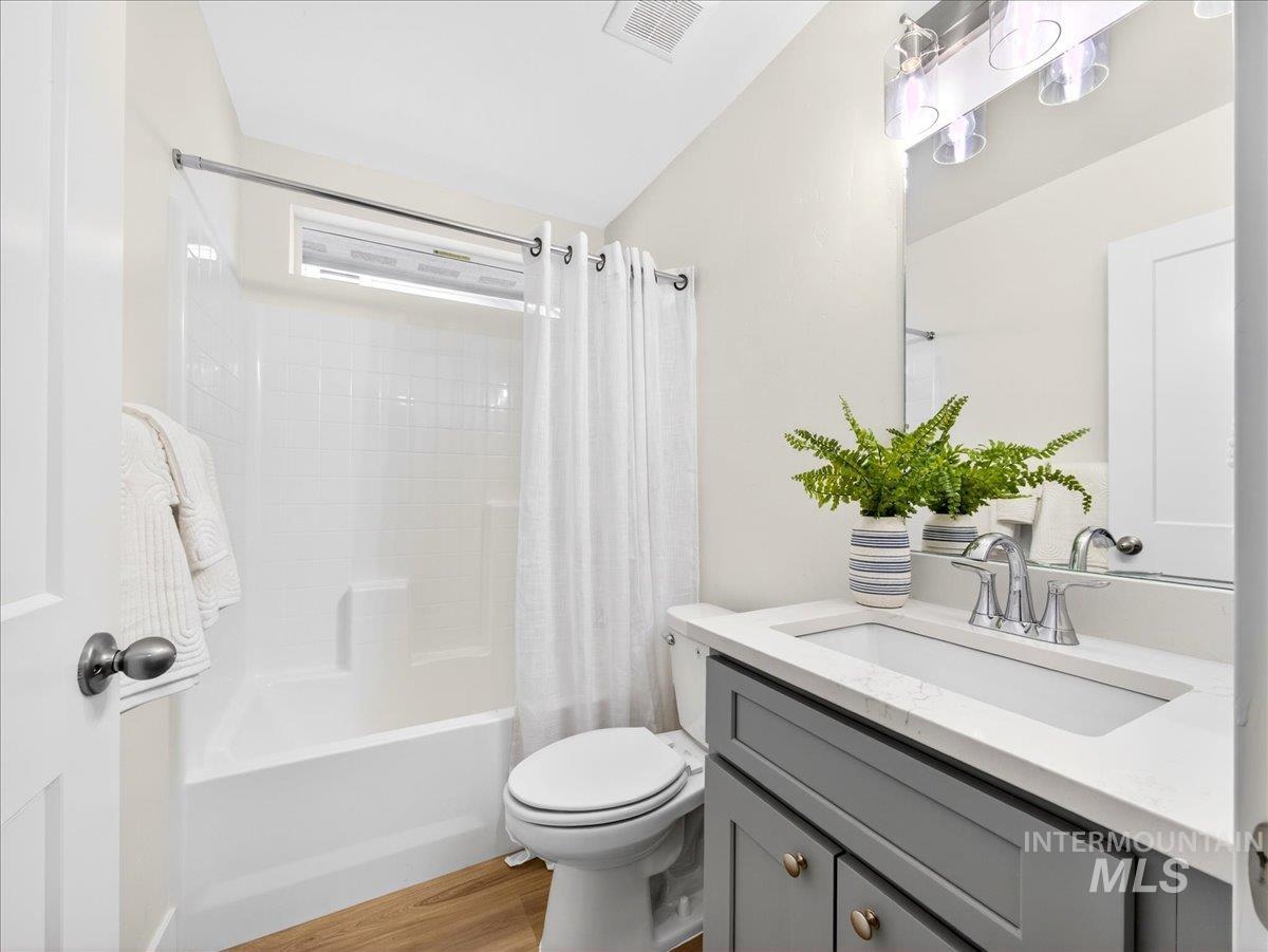 1611 Regency Way Emmett, ID 83617 - Photo 36 of 47 Bathroom with vanity, shower / bath combo with shower curtain, and light wood-style floors