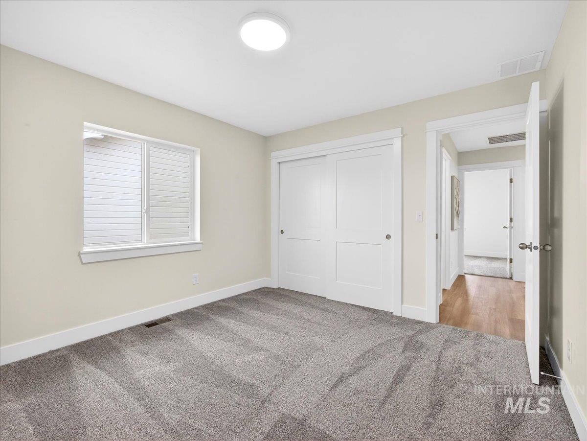 1611 Regency Way Emmett, ID 83617 - Photo 39 of 47 Unfurnished bedroom featuring light carpet and a closet