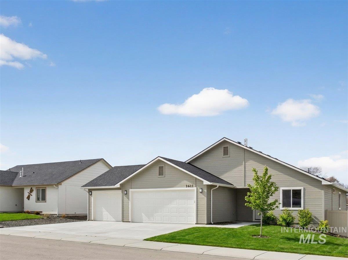 1611 Regency Way Emmett, ID 83617 - Photo 4 of 47 Ranch-style house featuring an attached garage, driveway, and a front lawn