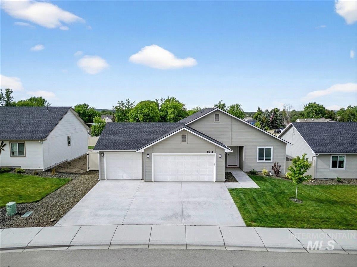 1611 Regency Way Emmett, ID 83617 - Photo 5 of 47 Ranch-style home featuring an attached garage, concrete driveway, and a front yard