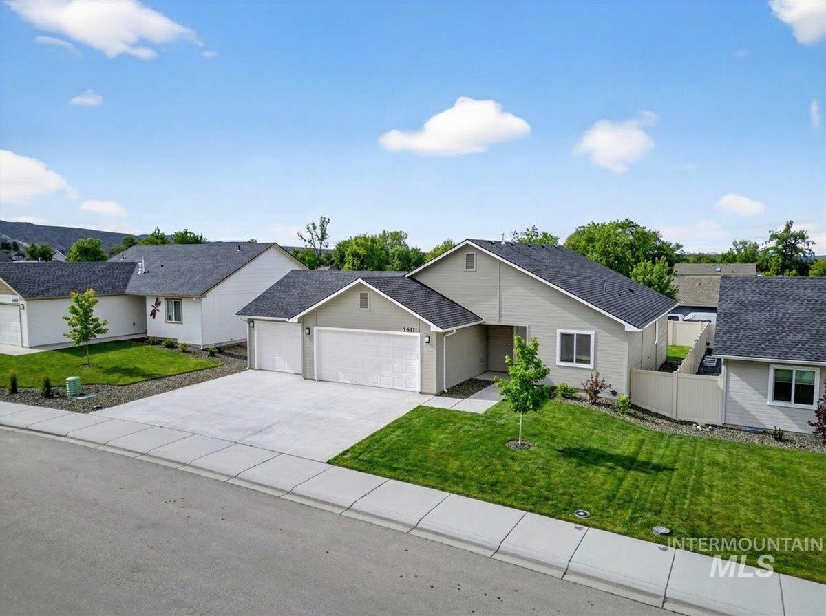 1611 Regency Way Emmett, ID 83617 - Photo 6 of 47 Ranch-style house with an attached garage, a front yard, concrete driveway, and a shingled roof