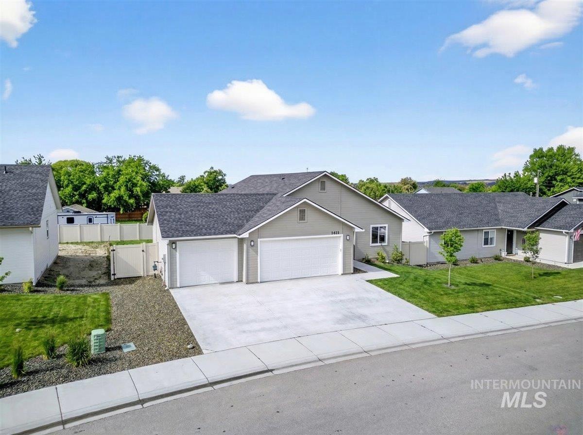 1611 Regency Way Emmett, ID 83617 - Photo 7 of 47 Ranch-style house with an attached garage, driveway, a gate, and roof with shingles