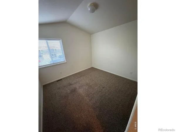 a view of an empty room with windows