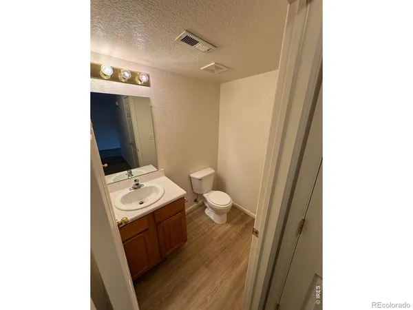 a bathroom with a toilet a sink and a mirror