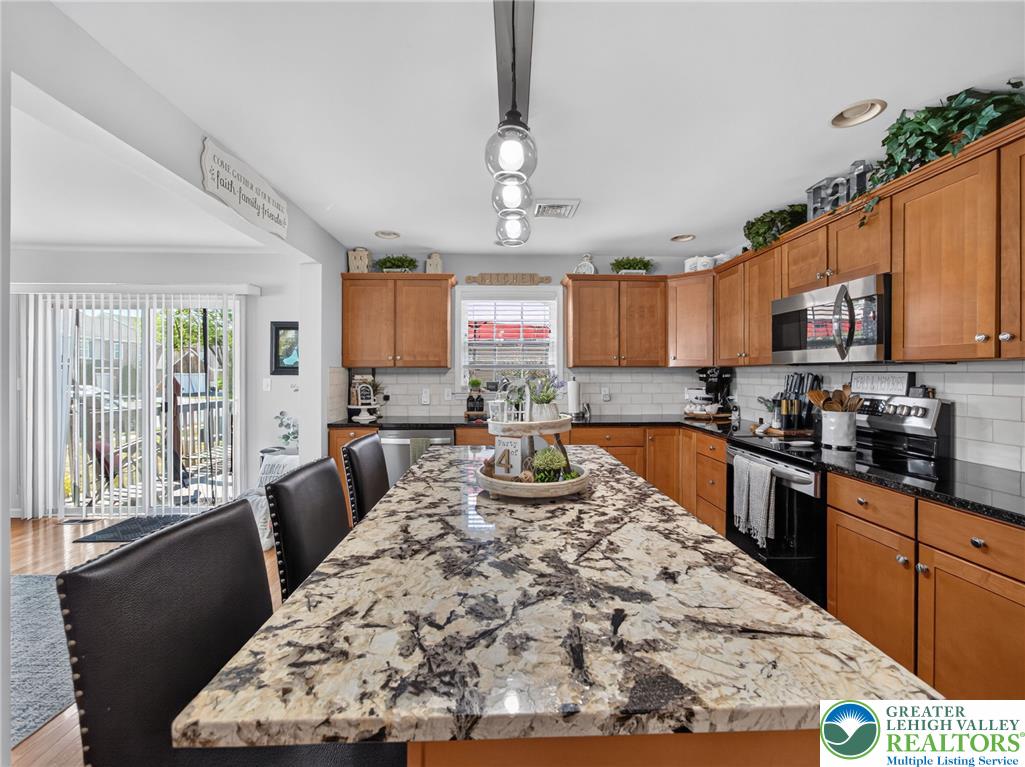 4148 Ross Road Bethlehem, PA 18020 - Photo 32 of 67 A well-appointed kitchen showcasing a spacious island with ample seating and durable granite countertops.