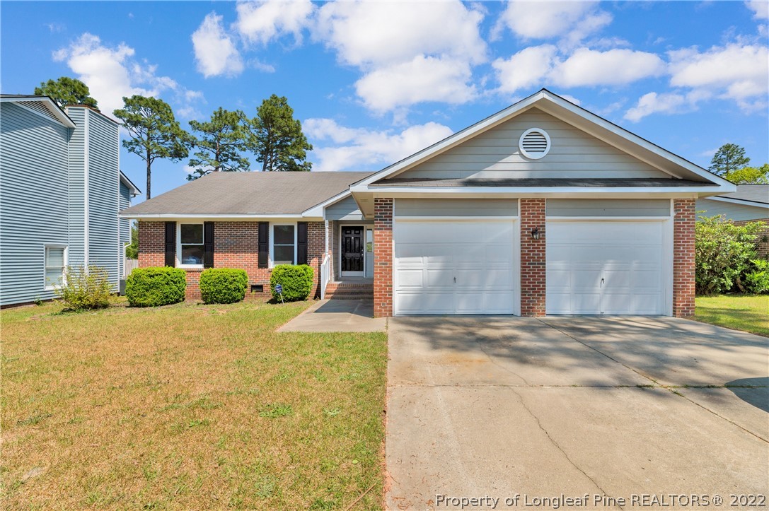 709 Riyhad Road Fayetteville, NC 28314 - Photo 1 of 29 a front view of a house with a yard and garage