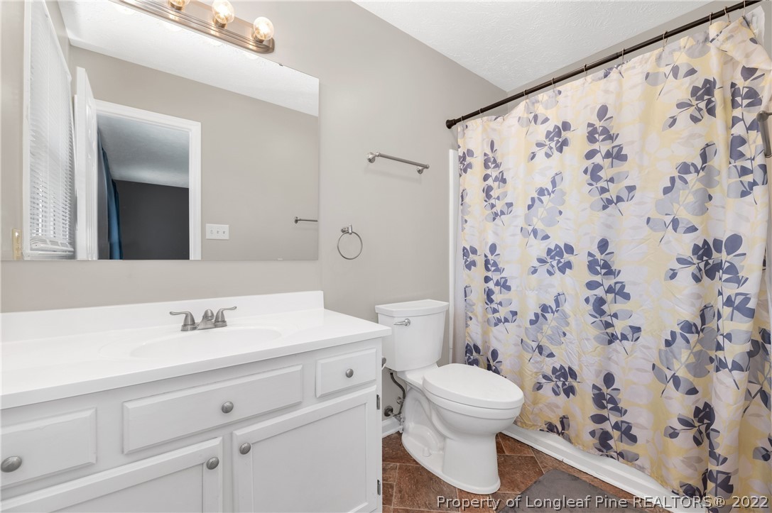 709 Riyhad Road Fayetteville, NC 28314 - Photo 17 of 29 a bathroom with a sink toilet and shower