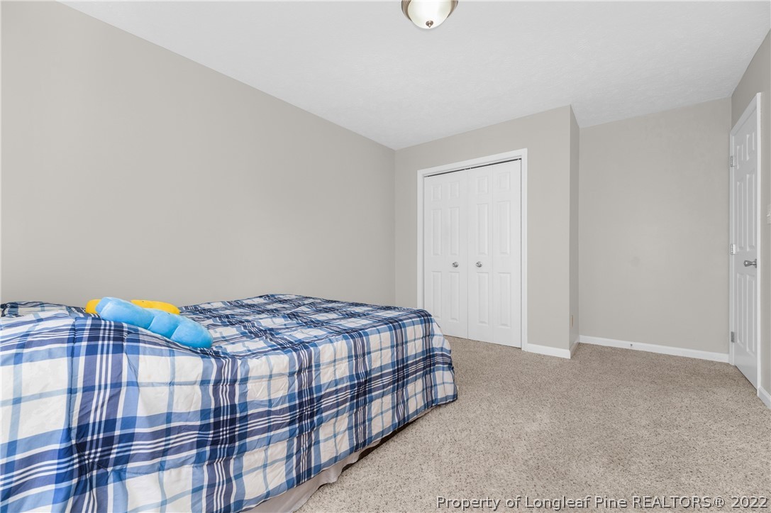 709 Riyhad Road Fayetteville, NC 28314 - Photo 20 of 29 a bedroom with a bed and a window