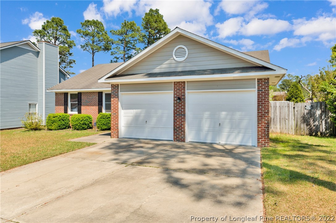 709 Riyhad Road Fayetteville, NC 28314 - Photo 2 of 29 a front view of a house with a yard and garage
