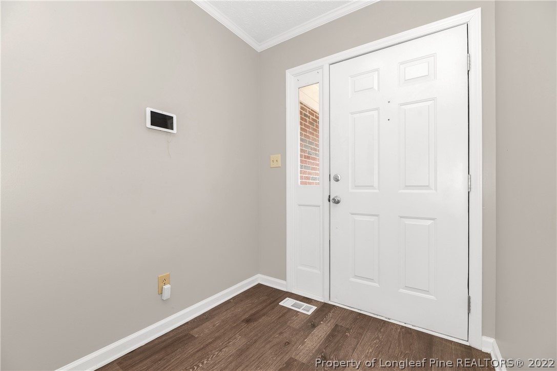 709 Riyhad Road Fayetteville, NC 28314 - Photo 5 of 29 an empty room with wooden floor and closet