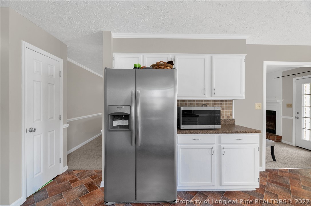 709 Riyhad Road Fayetteville, NC 28314 - Photo 8 of 29 a kitchen with white cabinets and stainless steel appliances