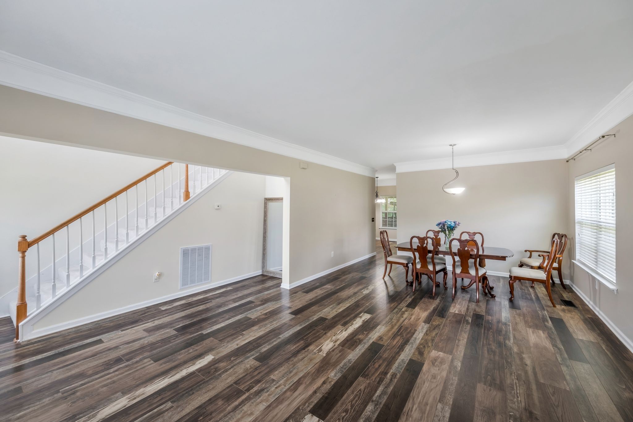 1757 Shane Drive Spring Hill, TN 37174 - Photo 12 of 30 a dining room with furniture wooden floor a rug and a painting