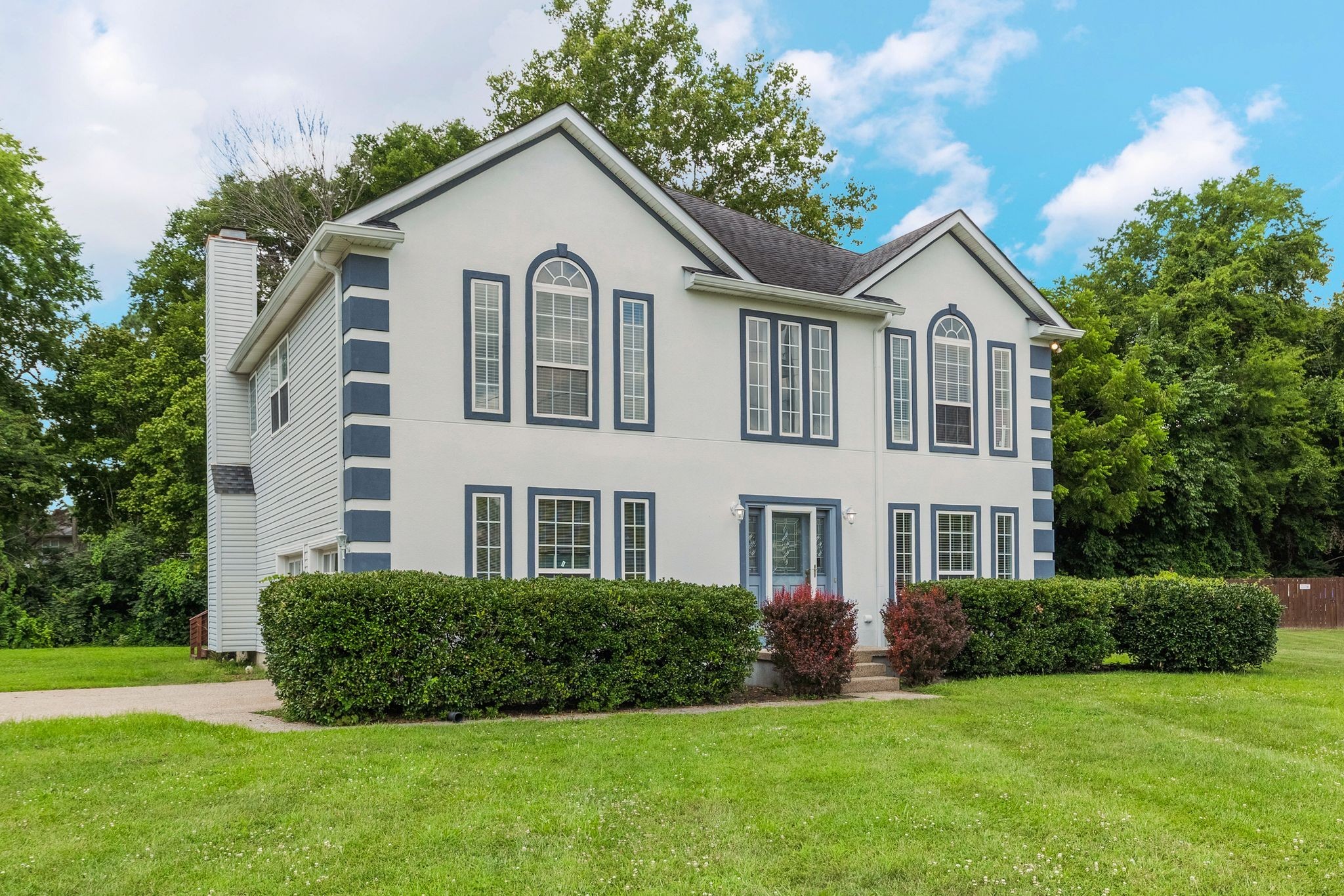 1757 Shane Drive Spring Hill, TN 37174 - Photo 2 of 30 a view of a white house next to a yard with big trees