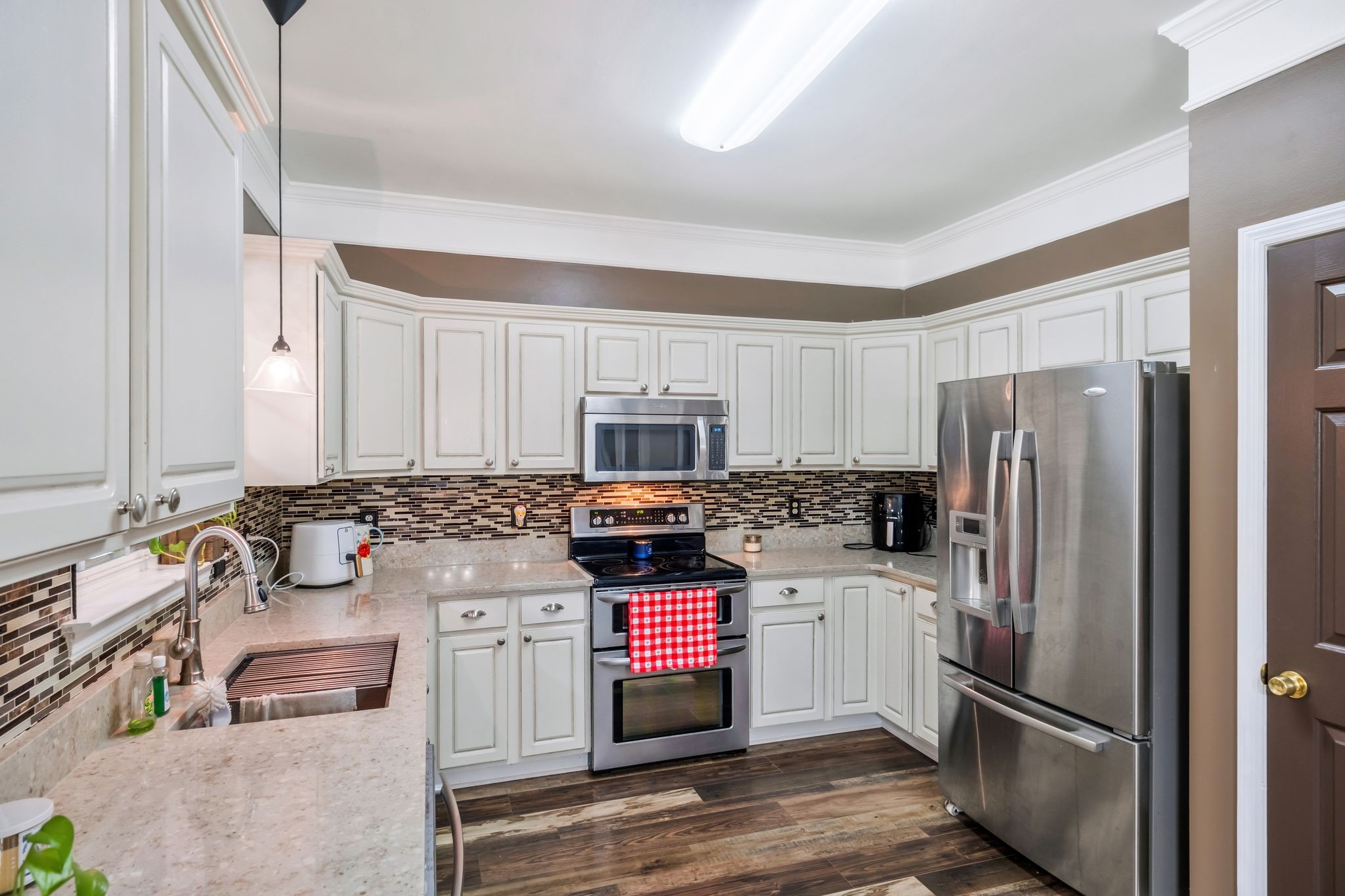1757 Shane Drive Spring Hill, TN 37174 - Photo 24 of 30 a kitchen with stainless steel appliances a stove a sink and a refrigerator
