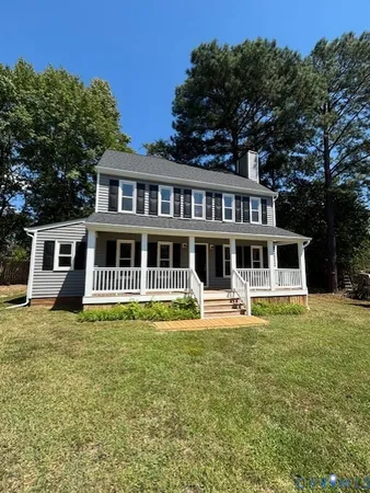 a front view of a house with a yard table and chairs