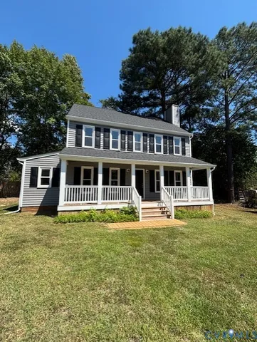 a front view of a house with a yard table and chairs