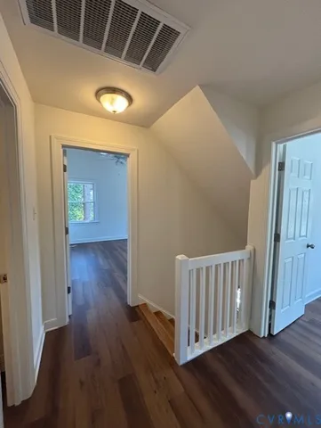 a view of hallway with wooden floor