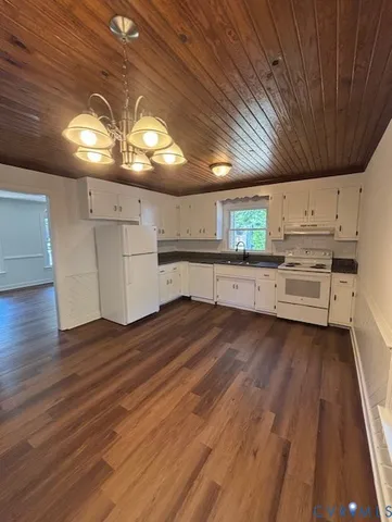 a kitchen with a wooden floor and window