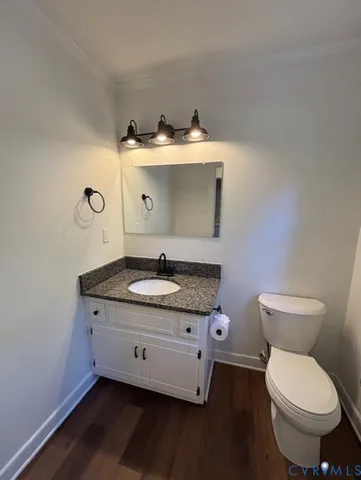 a bathroom with a granite countertop toilet sink and mirror