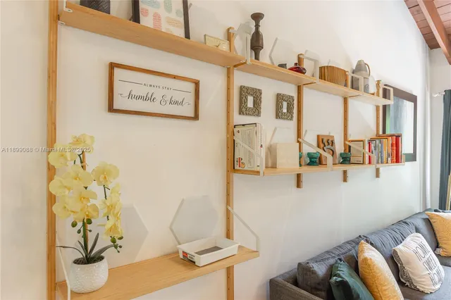 a kitchen with a table chairs window and cabinets