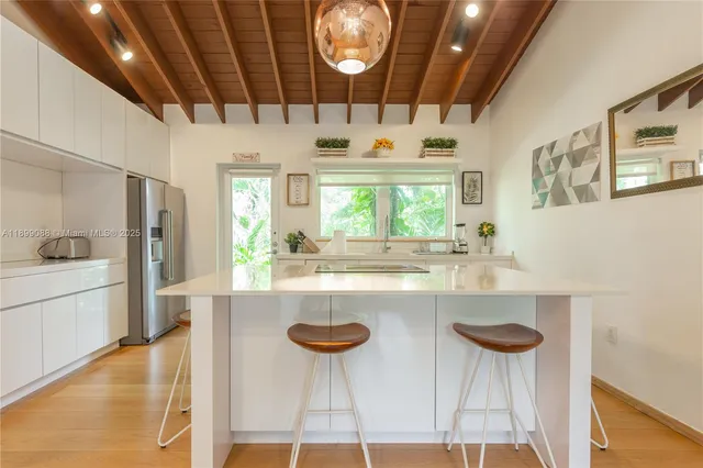 a spacious bathroom with a sink and a large mirror
