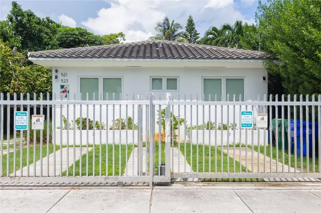 a view of a house with a garden and plants
