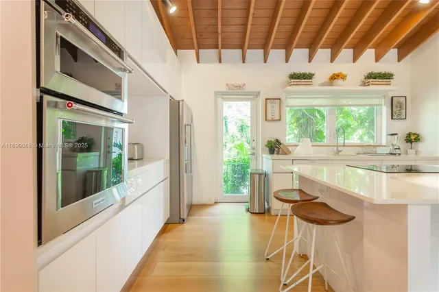 a kitchen with a sink and a large window