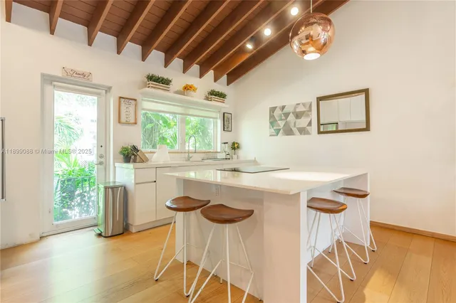 a kitchen with granite countertop a sink a stove and cabinets