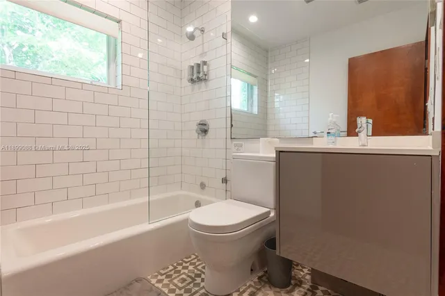 a large bed sitting in a bedroom next to a window