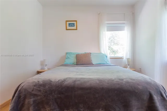 a bedroom with a bed and a chair