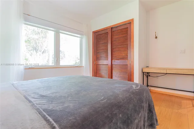 a bedroom with a bed and a chair