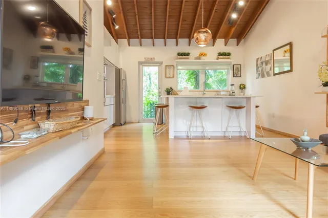 a large white kitchen with a large window