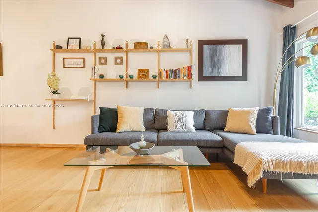 a living room with furniture and a wall painting