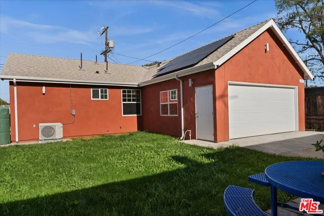 a front view of house with yard and outdoor seating