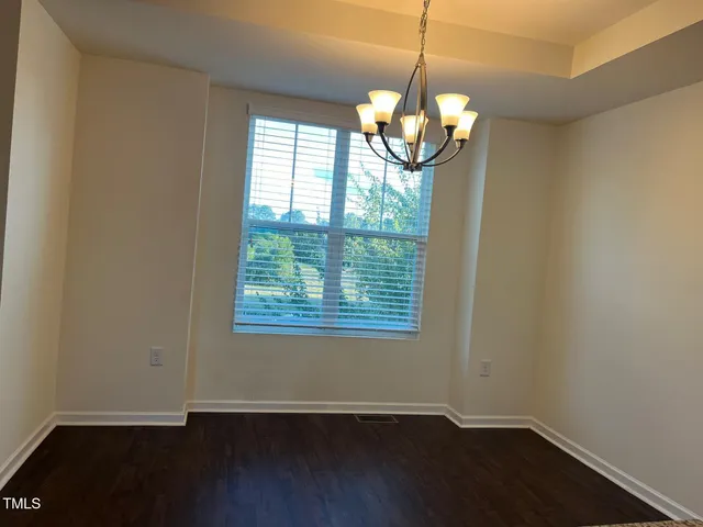 a view of a room with wooden floor and windows