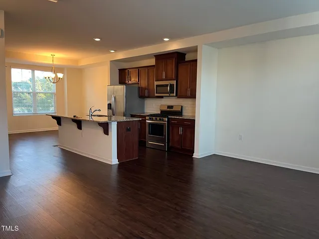 a view of kitchen with microwave and wooden floor