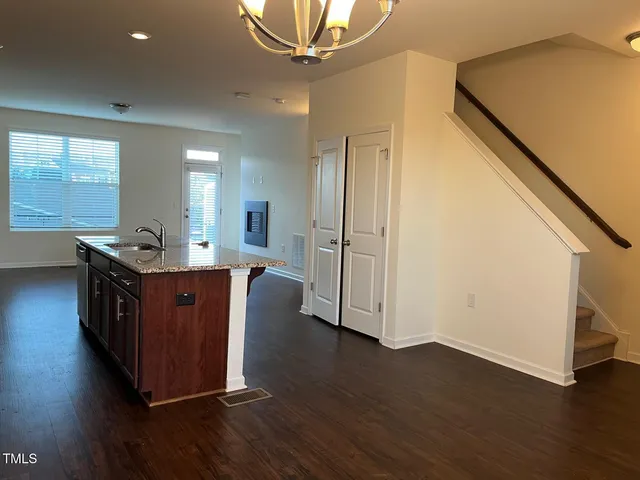 a living room with wooden floor and furniture