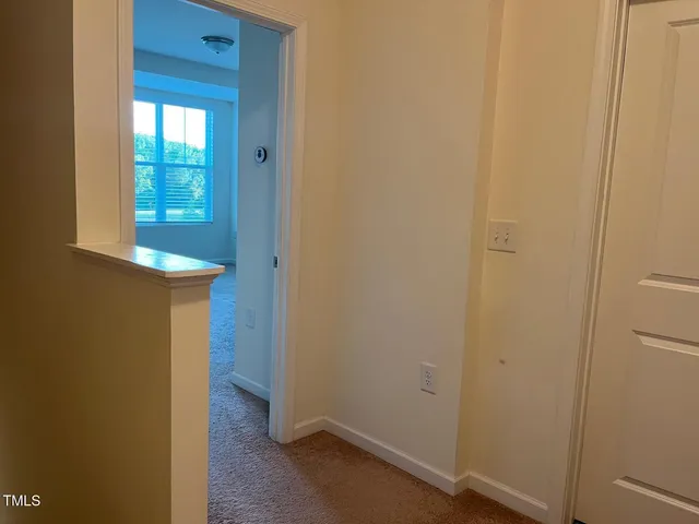 a view of a hallway with wooden door