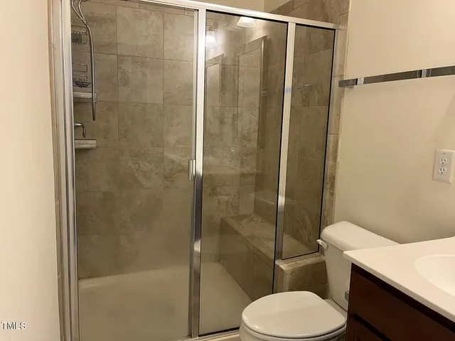 a bathroom with a toilet and a shower