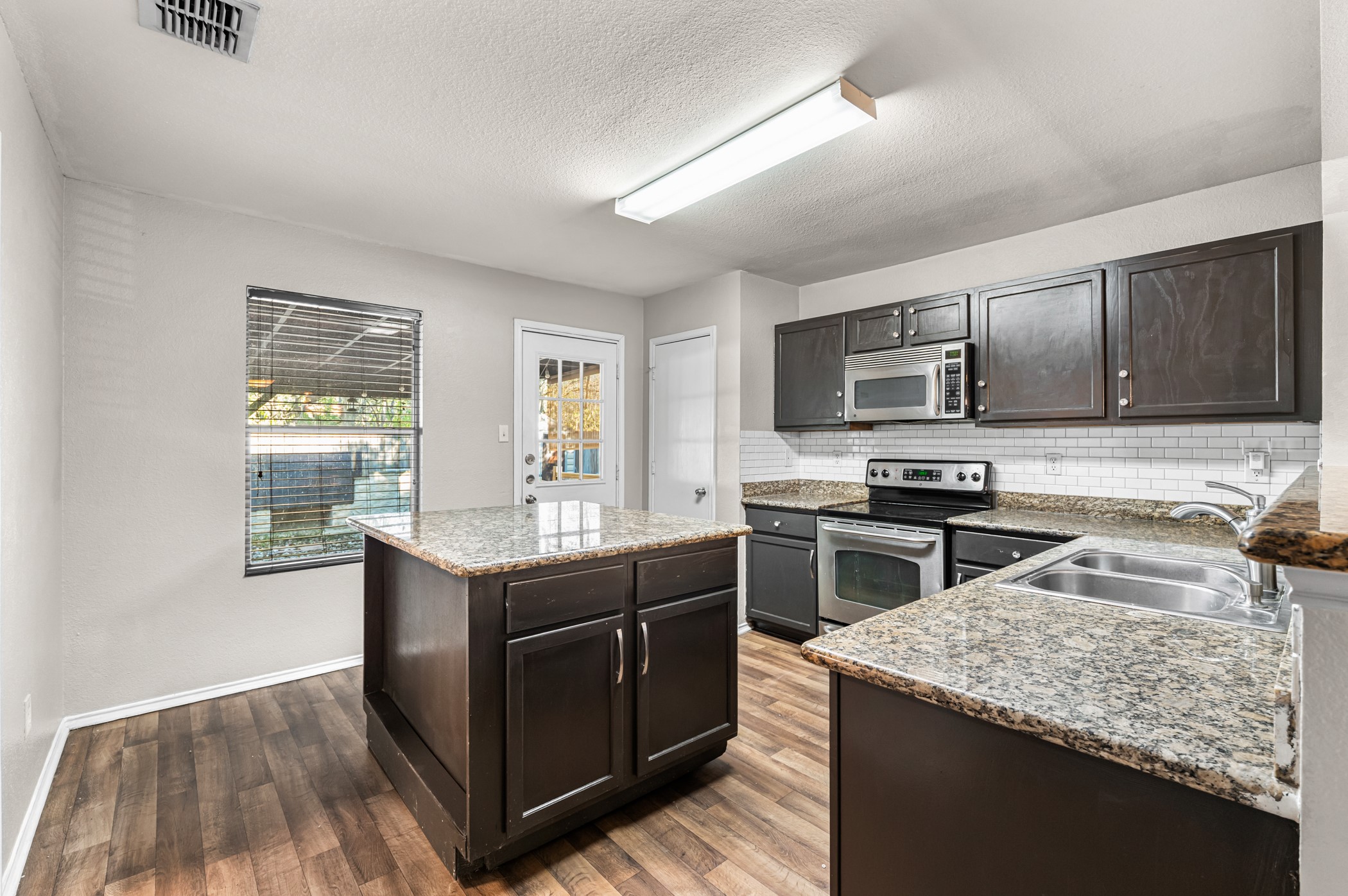 7731 Saddle Run Selma, TX 78154 - Photo 15 of 24 a kitchen with a stove sink and microwave